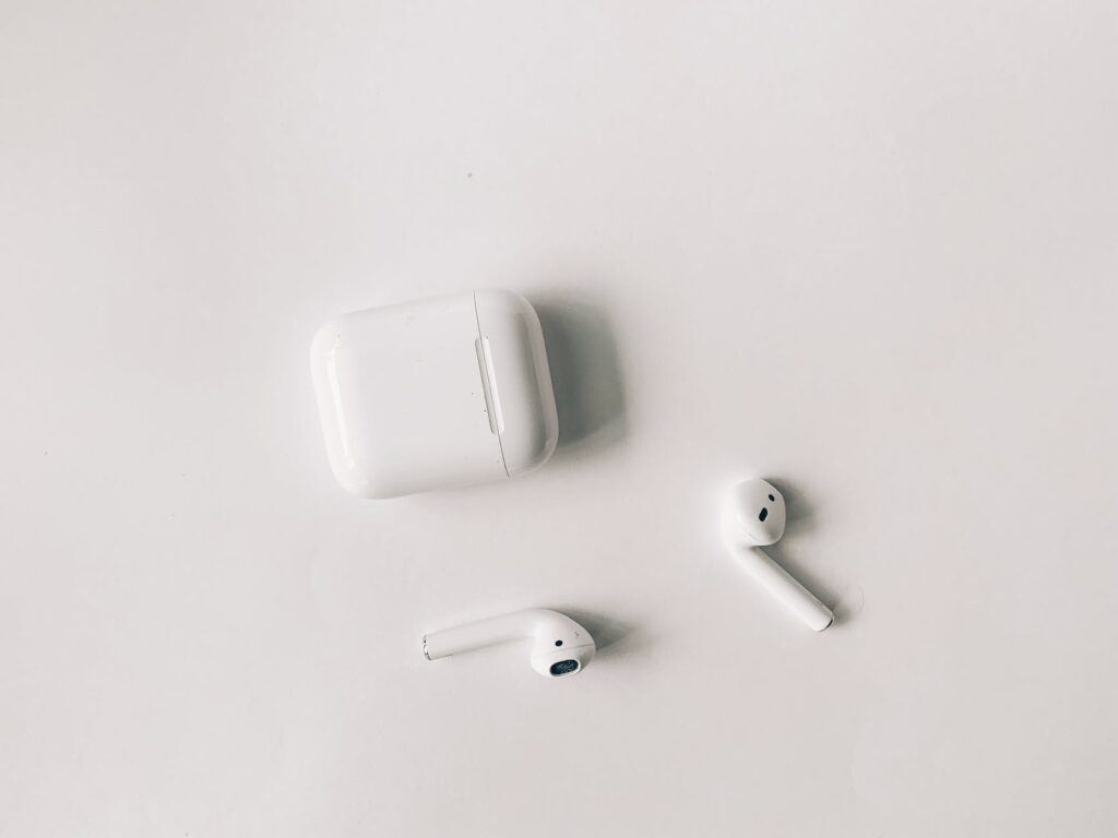 white apple airpods on white table
