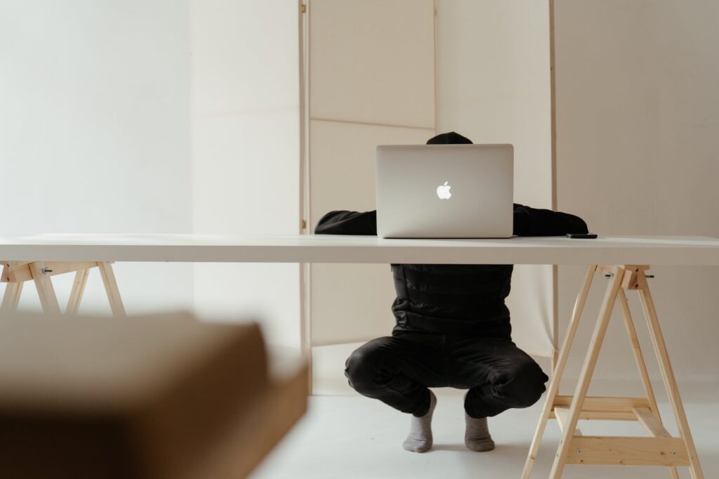 silver macbook on white table